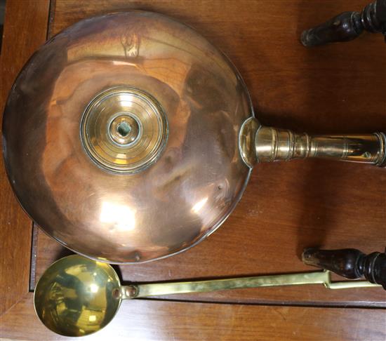 A Victorian copper warming pan and a brass ladle